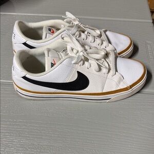 Nike White Sneakers with Black Swoosh and Gold Trim